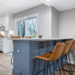 Beautiful blue seating peninsula in Okemos Michigan kitchen remodel from K Fedewa Builders