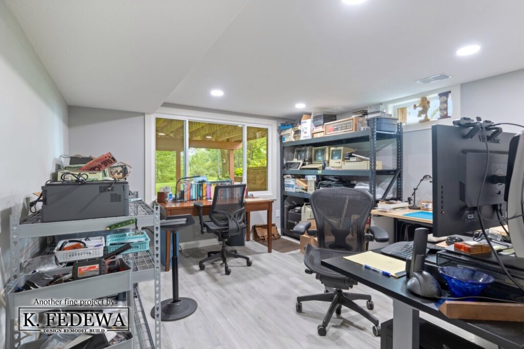 A home office in a remodeled Williamston, MI basement with a lot of computer equipment.