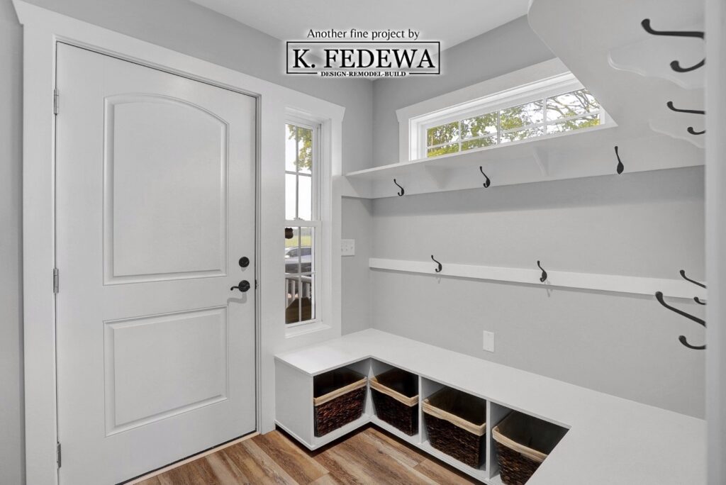 Mudroom with white shelves and storage for coats and such.