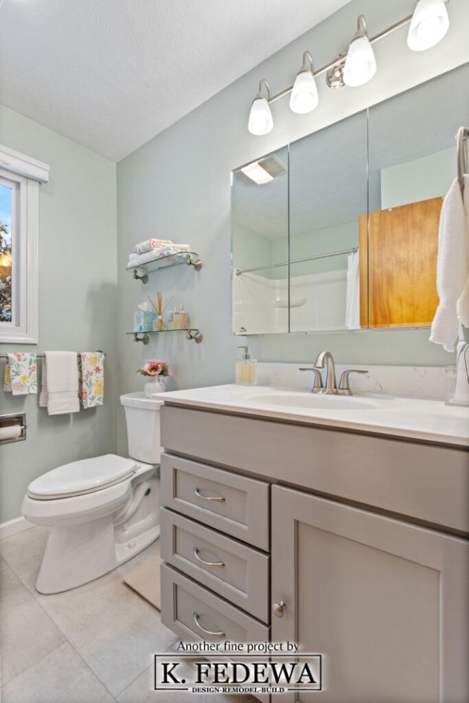 New grey/beige vanity with white countertop installed in bathroom.