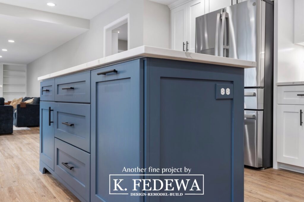 Close-up of cobalt blue cabinets in a kitchen island with white countertop.