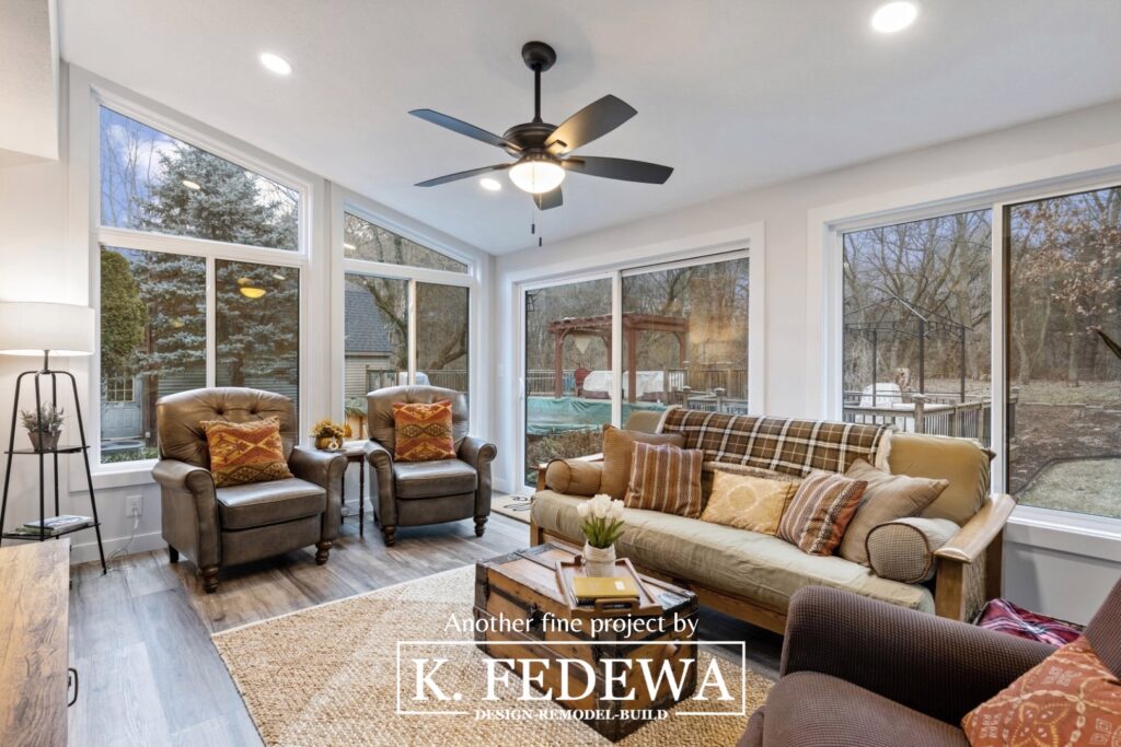 Interior photo of four-seasons room addition in Bath, MI with large comfortable furniture.