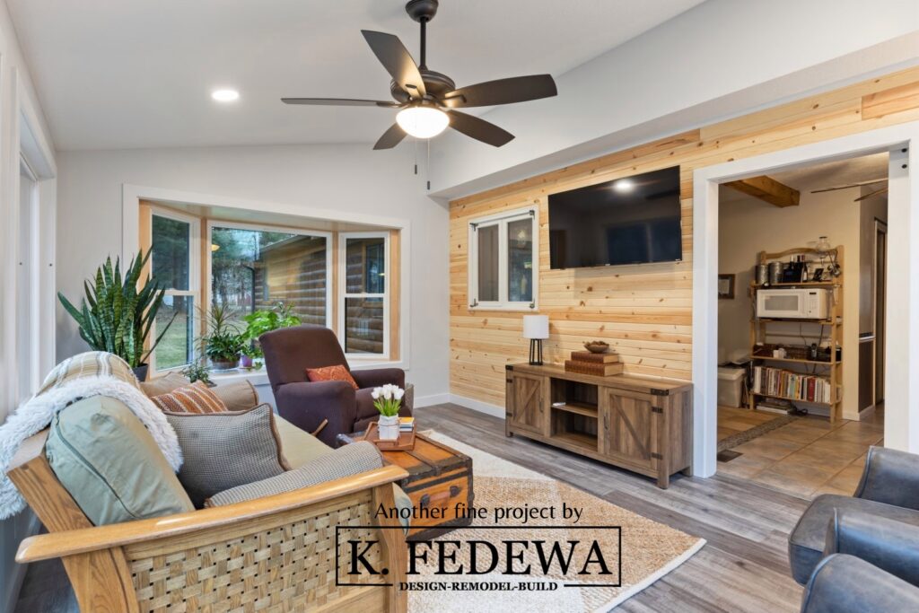 Beautiful four-seasons room in Bath, MI from K. Fedewa Builders with wood wall.