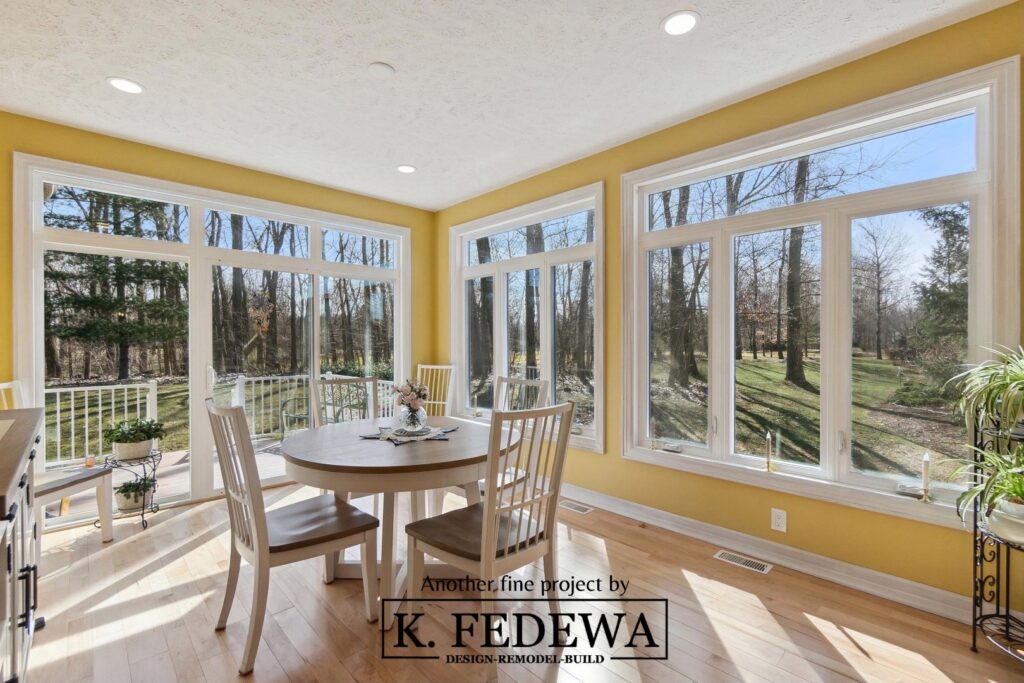 Dining table in the middle of Bath, MI addition from K. Fedewa Builders.