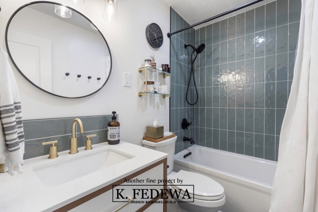 Beautiful bathroom remodel with teal green tile shower and wood vanity.