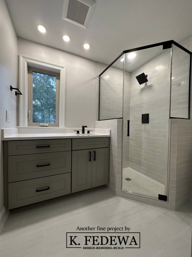 Beautiful remodeled bathroom with grey vanity, grey heated tile floor, and huge walk-in shower.