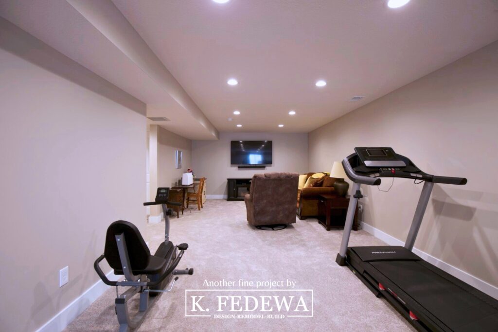 Finished basement in Williamston, MI showing a living room and workout area