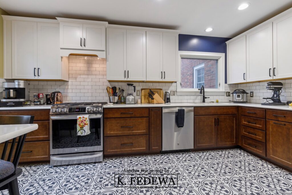 Beautiful kitchen remodel with dark wood cabinets on the bottom and white cabinets on the top. There is Moroccan-style tile on the kitchen floor as well.