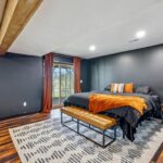 Dewitt Michigan Remodeled Basement into Master Suite from K Fedewa Builders - view of bed and sliding door to outside