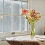 Four season room remodel in Lansing MI by K Fedewa Builders - interior view of large window and dining table