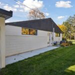 Garage to Bedroom Conversion in East Lansing by K Fedewa Builders - Exterior Rear of House