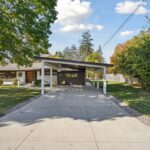 Garage to Bedroom Conversion in East Lansing by K Fedewa Builders - Exterior Carport Wideshot
