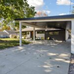 Garage to Bedroom Conversion in East Lansing by K Fedewa Builders - Exterior Carport