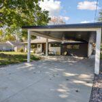 Garage to Bedroom Conversion in East Lansing by K Fedewa Builders - Exterior Carport