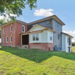 Huge Farmhouse Remodel with Additions in St Johns MI from K Fedewa Builders - Exterior Angle View of Rear of House
