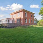 Huge Farmhouse Remodel with Additions in St Johns MI from K Fedewa Builders - Exterior Angle View of Rear of House