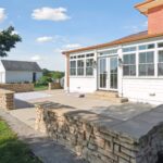 Huge Farmhouse Remodel with Additions in St Johns MI from K Fedewa Builders - Exterior View of Patio and Sunroom