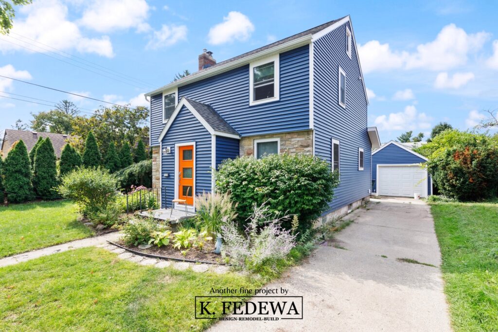 East Lansing, Michigan home with new blue siding white windows and grey roof